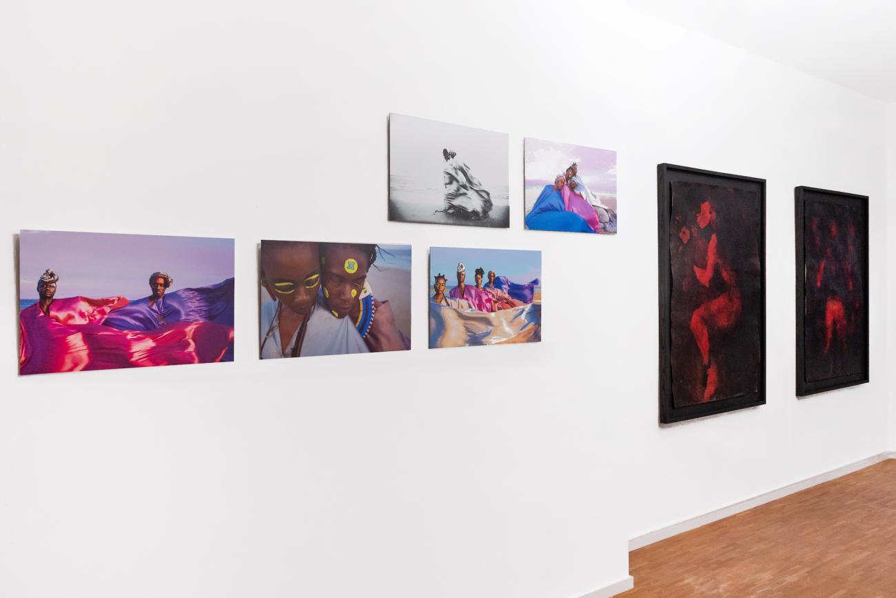 Installation view of photographs by Kwasi Darko and paintings by Adelaide Damoah
